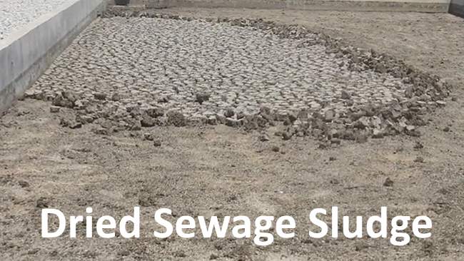 Image shows dried sewage sludge, after drying in the open.