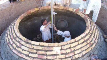 Buried masonry biogas digester tank during construction.