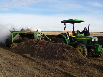 Turning and adding water to windrow compost at a composting site experiment. Turning and adding water to windrow compost at a composting site experiment.