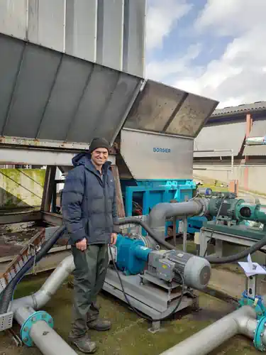 Edward Vaughan standing by the Borger Powerfeed.