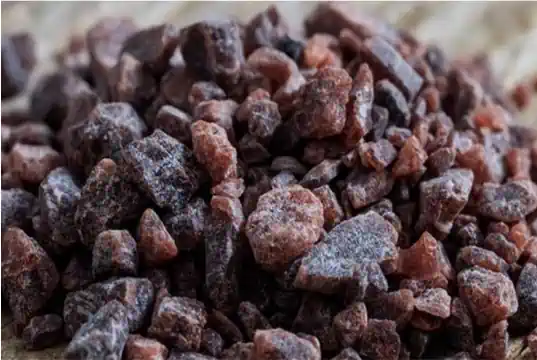 A close up photo of black rock salt.