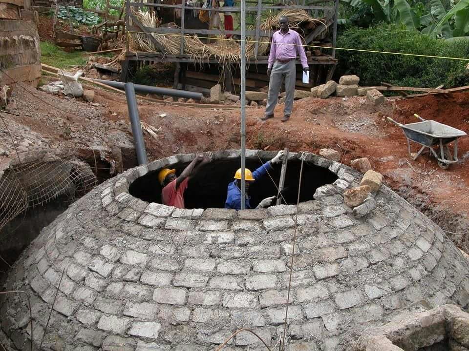Skilled brick dome builders near completion of a Fixed Dome Biogas Plant. Skilled brick dome builders near completion of a Fixed Dome Biogas Plant.
